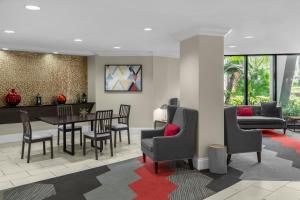 a living room with a table and chairs at Four Points by Sheraton Orlando International Drive in Orlando