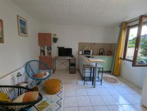 a kitchen with chairs and a table in a room at Chez Marie et Hugo in Brest +9 photos