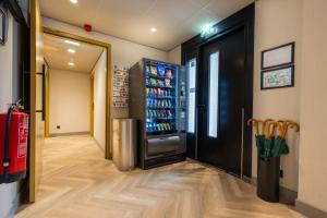 a vending machine in a store with a drink refrigerator at Dutch Design Hotel Vondelpark in Amsterdam