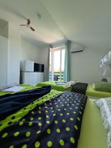 a bedroom with two beds with green and black sheets at Quiet Forest Retreat with Pool in Borovnica +32 photos