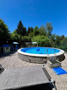 a large swimming pool in a yard at Quiet Forest Retreat with Pool in Borovnica