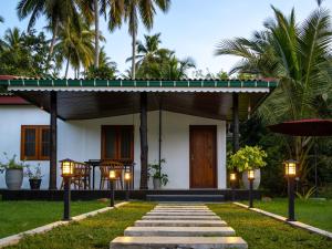 a house with lights in front of it at The Loons Lake Villa in Tangalle