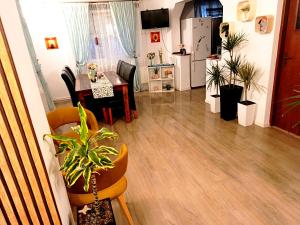 a kitchen and living room with a table and chairs at Casa Naomi in Eforie Nord