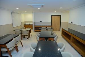 a classroom with tables and chairs and a chalkboard at BHAVANIS Vista By ICON in Hosūr