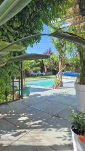 a patio with a canopy and a swimming pool at La Maison D'ayona in Herrlisheim-près-Colmar