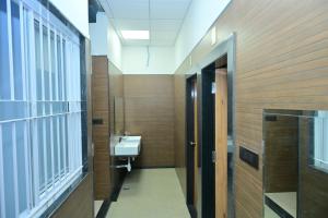 a bathroom with a sink and a mirror at BHAVANIS Vista By ICON in Hosūr