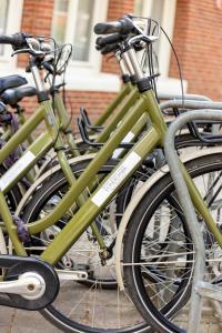a group of green bikes parked next to each other at Dutch Design Hotel Vondelpark in Amsterdam +42 photos