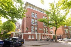 a car parked in front of a brick building at Dutch Design Hotel Vondelpark in Amsterdam