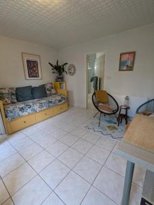 a bedroom with a bed and a table and chairs at Chez Marie et Hugo in Brest
