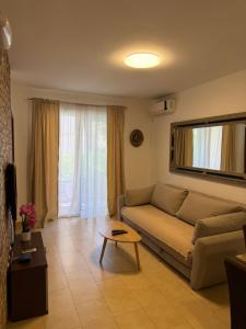 a living room with a couch and a table at Apartmani Kovačević in Kotor