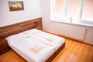 a bedroom with a bed with two hats on it at Mliečna víla in Turčianske Teplice