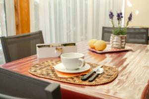a table with a cup of coffee on a plate at Ancora Apartments in Marina di Massa +21 photos