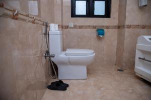 a bathroom with a toilet and a sink at UNPLAN Kathmandu in Kathmandu