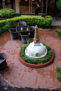 a small fountain with a pagoda in a courtyard at UNPLAN Kathmandu in Kathmandu