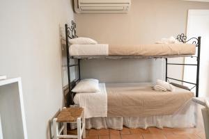 a room with two bunk beds and a table at Ancora Apartments in Marina di Massa