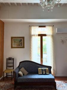 a living room with a couch and a window at La casa di Hermes in Imola +70 photos