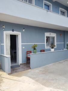 a blue building with a counter and a window at Vila Marini in Lin +2 photos