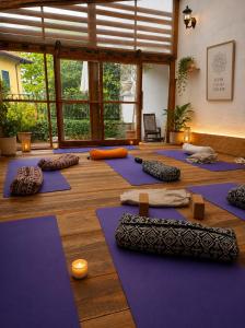 a yoga room with purple mats on the floor at Monastero Retreat - Villa con SPA in Lanzo dʼIntelvi
