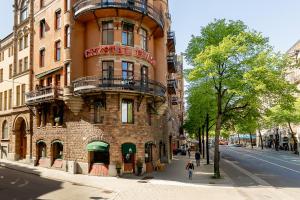 a tall brick building on a city street at Crystal Plaza Hotel in Stockholm +43 photos