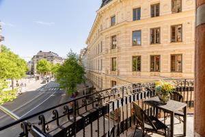 a balcony with a table and chairs on a city street at Crystal Plaza Hotel in Stockholm