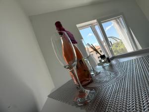a wine glass sitting on a table in a room at Luxury Apartament in Bacău +3 photos