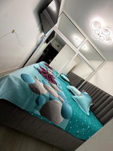 a bed in a room with a bedspread with whales on it at Luxury Apartament in Bacău