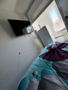 a room with a bed with a mirror on the wall at Luxury Apartament in Bacău
