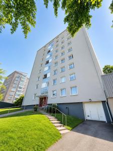 a large white building with a stairway in front of it at Kotkan Studio in Kotka