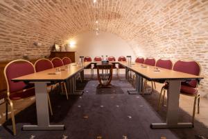 a room with tables and chairs and a brick wall at Teritoria Hôtel Wilson in Dijon