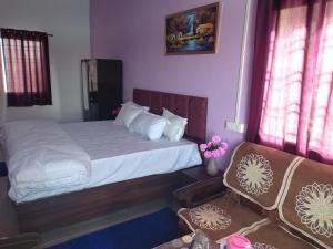 a small bedroom with a bed and a couch at Hotel madhav regency bhopal in Misrod