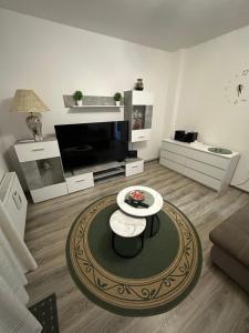 a living room with a couch and a coffee table at Apartment & Apartment Studio Deželjin in Senj