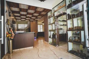 a room with a lobby with a counter and many shelves at S K Legacy Hotel in Mysore