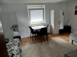a room with a table and chairs and a window at Ferienwohnung Schießstatt in Bad Saulgau +29 photos