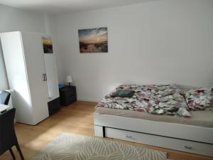 a bedroom with a bed and a dresser in it at Ferienwohnung Schießstatt in Bad Saulgau