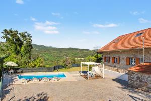 an external view of a house with a swimming pool at Casa Na Aldeia in Arões