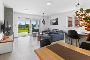 a living room with a couch and a table at Villa Tea by Rent Istria in Umag +37 photos