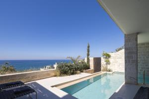 a swimming pool with a view of the ocean at My Cave Blue Iconic Designer Villa by etouri in Rethymno