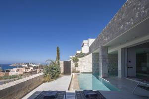 a house with a view of the ocean at My Cave Blue Iconic Designer Villa by etouri in Rethymno