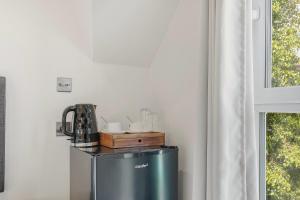 a kitchen with a small refrigerator and a window at London Star Hotel in London +68 photos