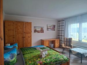 a bedroom with a bed with a stuffed rabbit on it at Landpension Bielatal - Raum in Raum