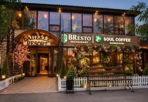 a store with a bench in front of a building at Baiterek Resort in Karagandy