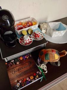 a table with a tea pot and a tortoise on it at Su Tostoiu alloggio privato in Càbras