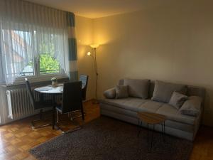 a living room with a couch and a table at Pension Zimmermann in Unteruhldingen
