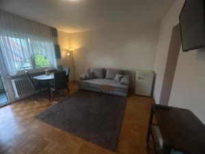 a living room with a couch and a table at Pension Zimmermann in Unteruhldingen