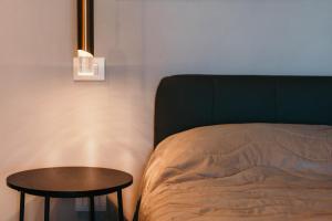 a bedroom with a bed and a table next to it at Appartamento Meda - Lakeside Leisure & Business in Cissano