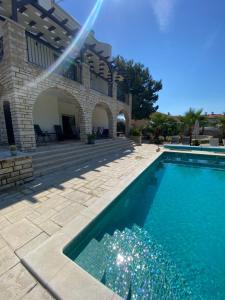 a swimming pool in front of a house at Villa Jalan in Vrsi