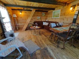 a living room with a couch and a table at Słoneczne Łąki in Wólka Soseńska