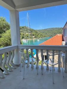 a balcony with chairs and a view of the water at Adriatic Retreat Mljet in Polače