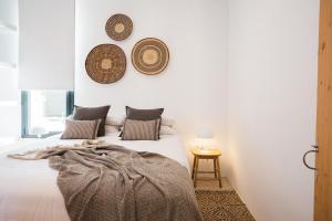 a bedroom with a bed with three plates on the wall at Canalola in Cala en Bosc