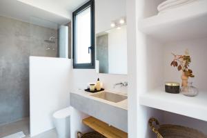 a bathroom with a sink and a mirror at Canalola in Cala en Bosc +12 photos